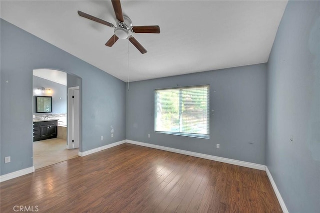 spare room with ceiling fan and hardwood / wood-style flooring