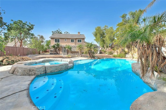 view of pool with an in ground hot tub