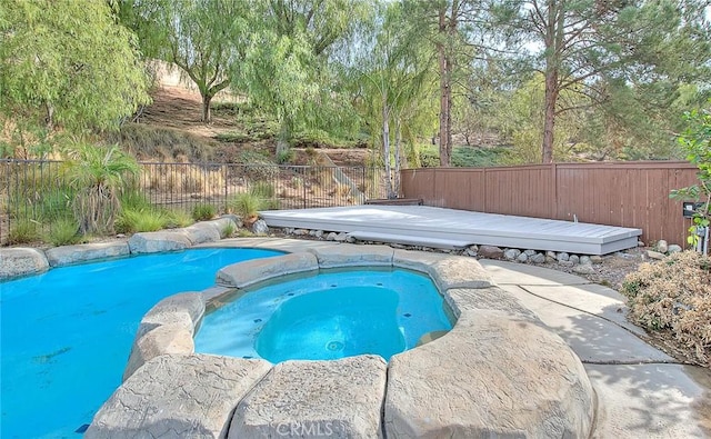 view of pool featuring an in ground hot tub