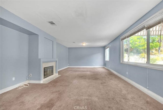 unfurnished living room featuring light colored carpet