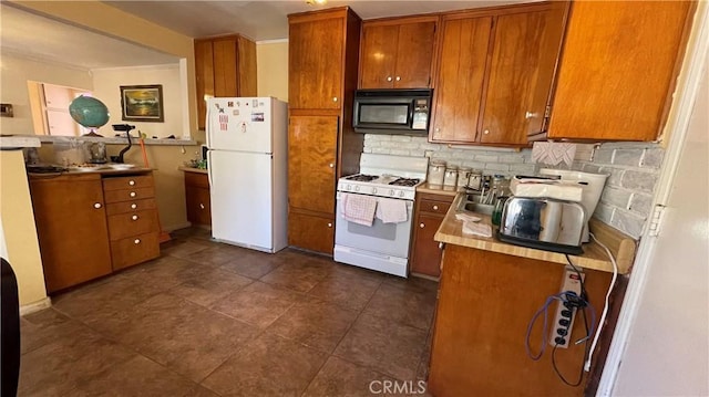 kitchen with decorative backsplash, sink, and white appliances