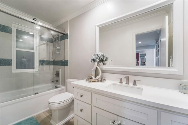 full bathroom with hardwood / wood-style flooring, enclosed tub / shower combo, vanity, toilet, and crown molding