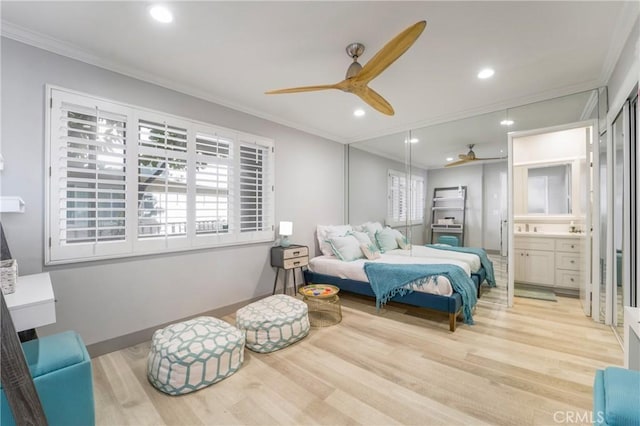 bedroom featuring ensuite bath, ornamental molding, and light wood-type flooring