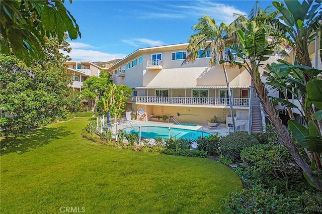 view of swimming pool featuring a yard and a patio area