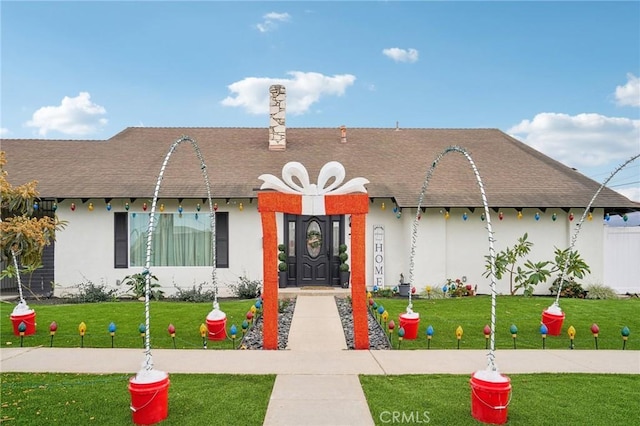 ranch-style home with a front yard