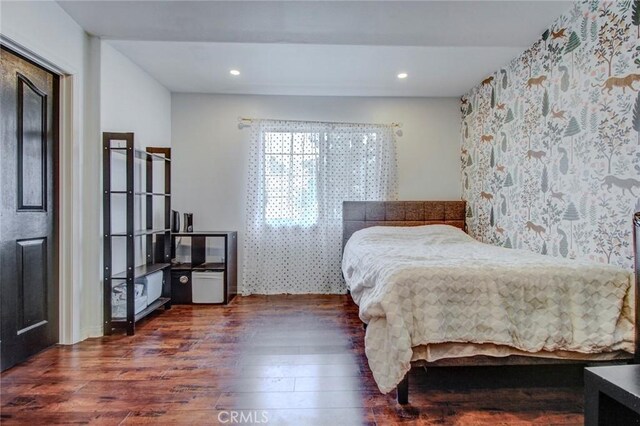 bedroom with dark wood-type flooring