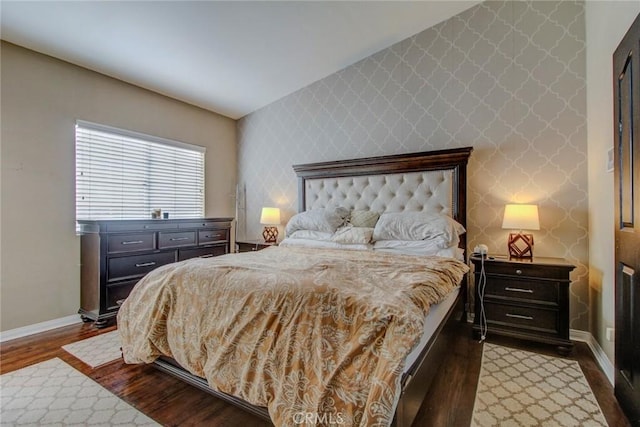 bedroom featuring vaulted ceiling and dark wood-type flooring