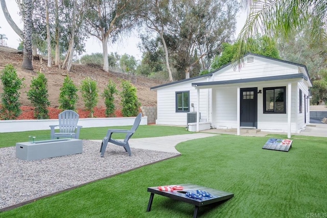 rear view of property featuring a yard