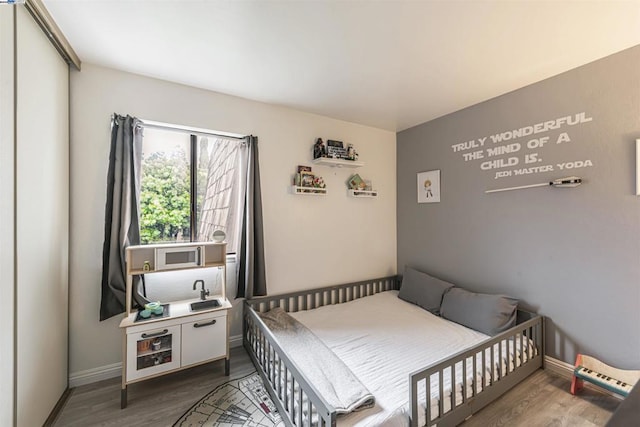 bedroom with dark hardwood / wood-style floors