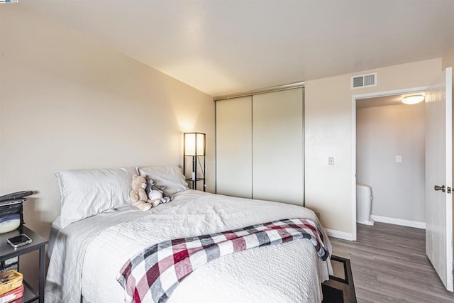 bedroom featuring a closet and hardwood / wood-style flooring