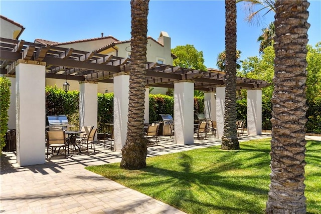 view of patio / terrace with area for grilling and a pergola