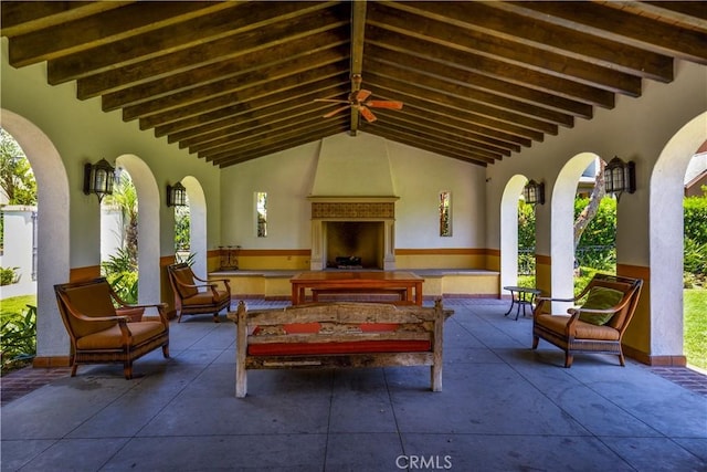 view of patio / terrace featuring an outdoor living space with a fireplace and ceiling fan