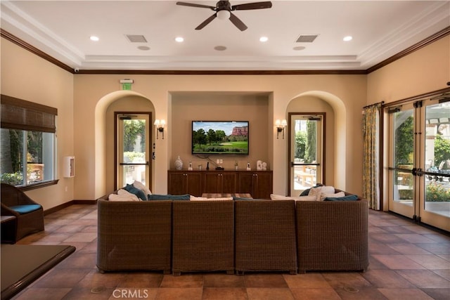 living room featuring crown molding, french doors, ceiling fan, and a healthy amount of sunlight