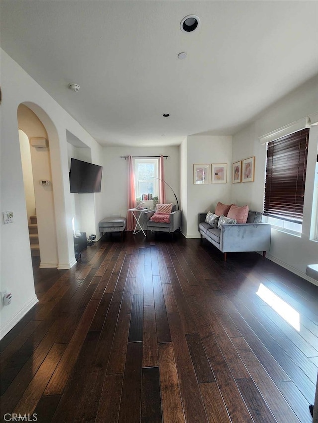 unfurnished living room featuring dark wood-type flooring