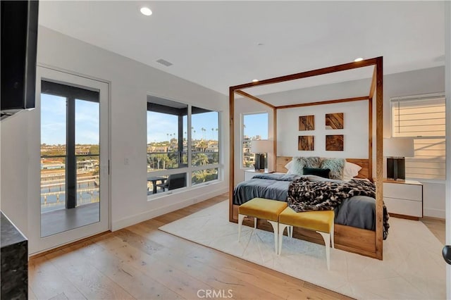 bedroom with access to outside and light hardwood / wood-style flooring