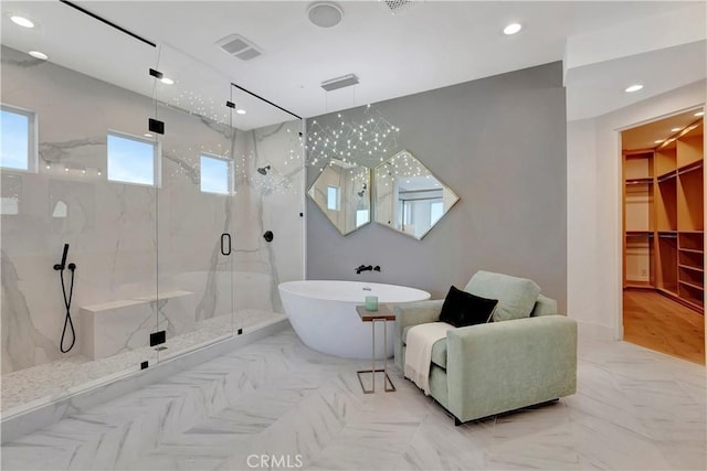 bathroom featuring separate shower and tub