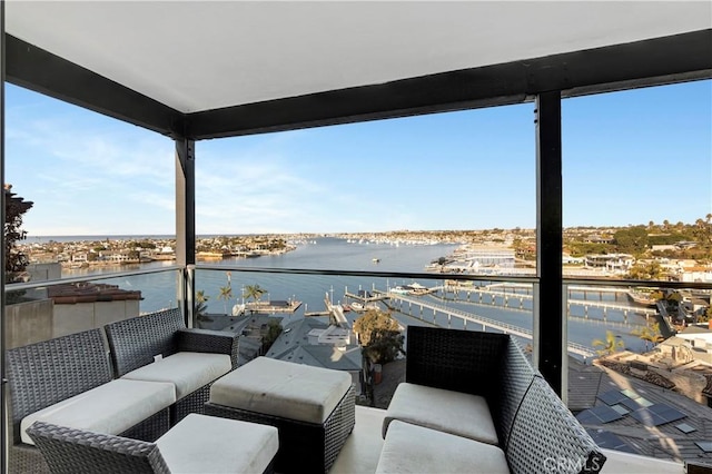 balcony with an outdoor living space and a water view