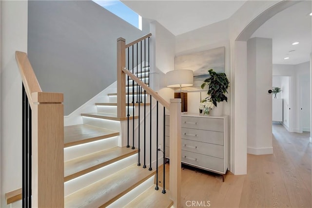 staircase with hardwood / wood-style floors