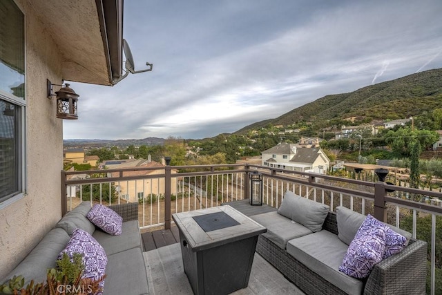 wooden deck featuring a mountain view and an outdoor living space