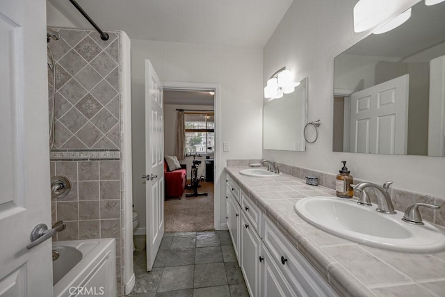 full bathroom featuring vanity, toilet, and tiled shower / bath combo