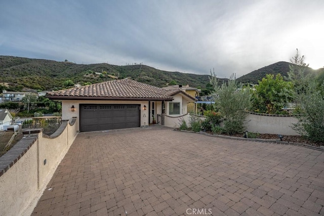 view of front of house with a mountain view and a garage