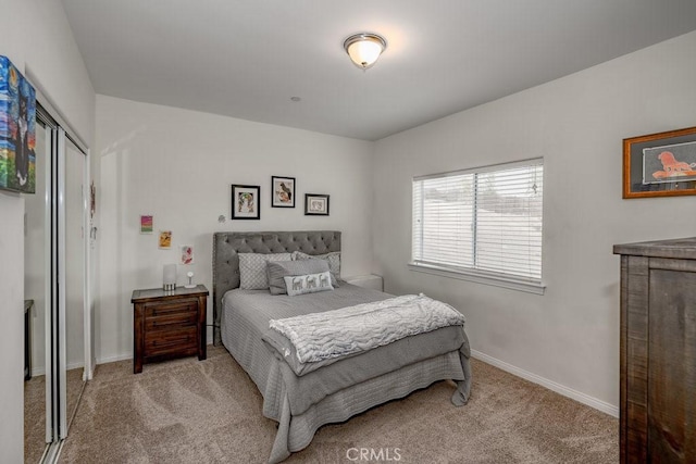 bedroom featuring light colored carpet and a closet