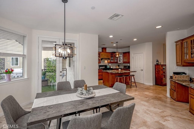 dining space featuring a notable chandelier