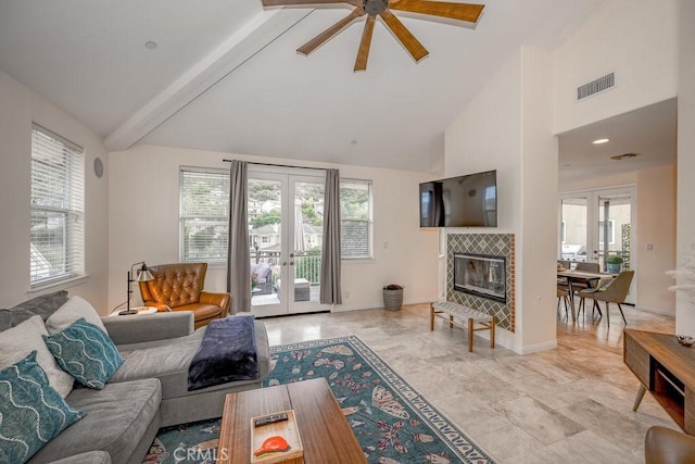 living room featuring french doors, high vaulted ceiling, ceiling fan, and a healthy amount of sunlight