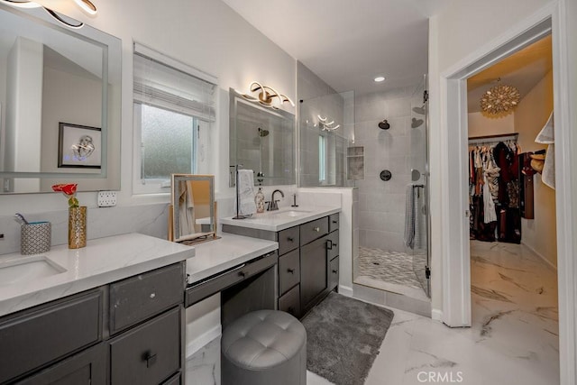 bathroom with tiled shower and vanity