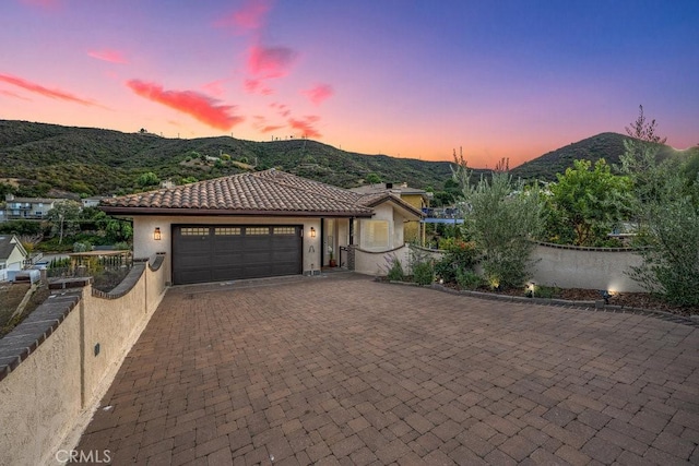 view of front of home featuring a mountain view and a garage