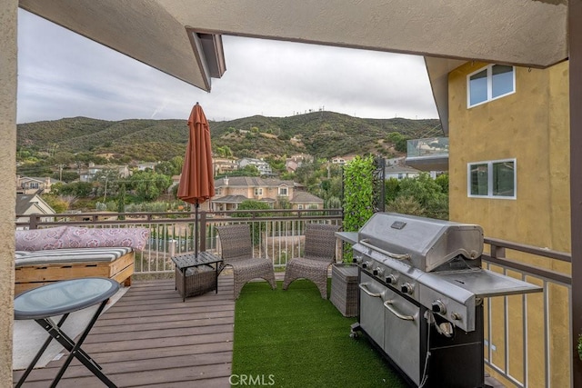 wooden deck featuring a mountain view and grilling area