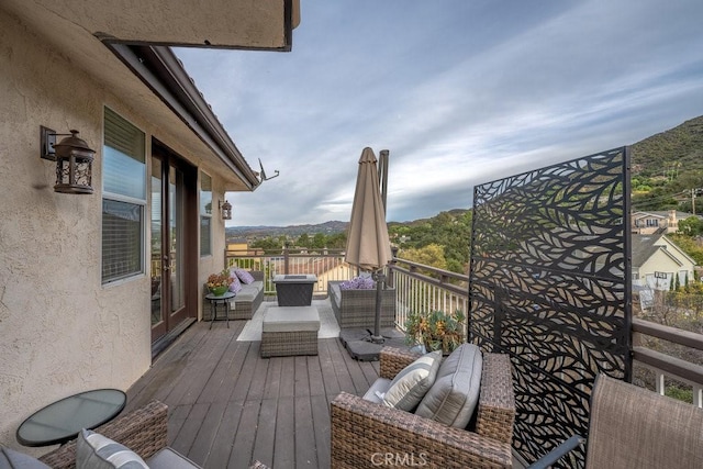 wooden deck with outdoor lounge area and a mountain view