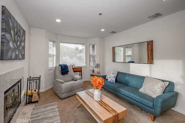 carpeted living room featuring a fireplace