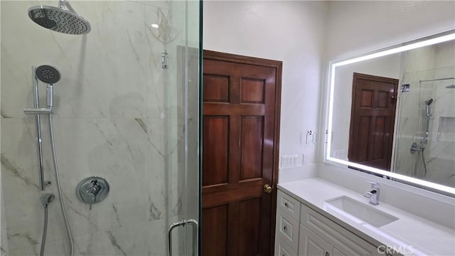 bathroom featuring vanity and an enclosed shower