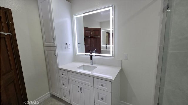 bathroom featuring vanity and an enclosed shower