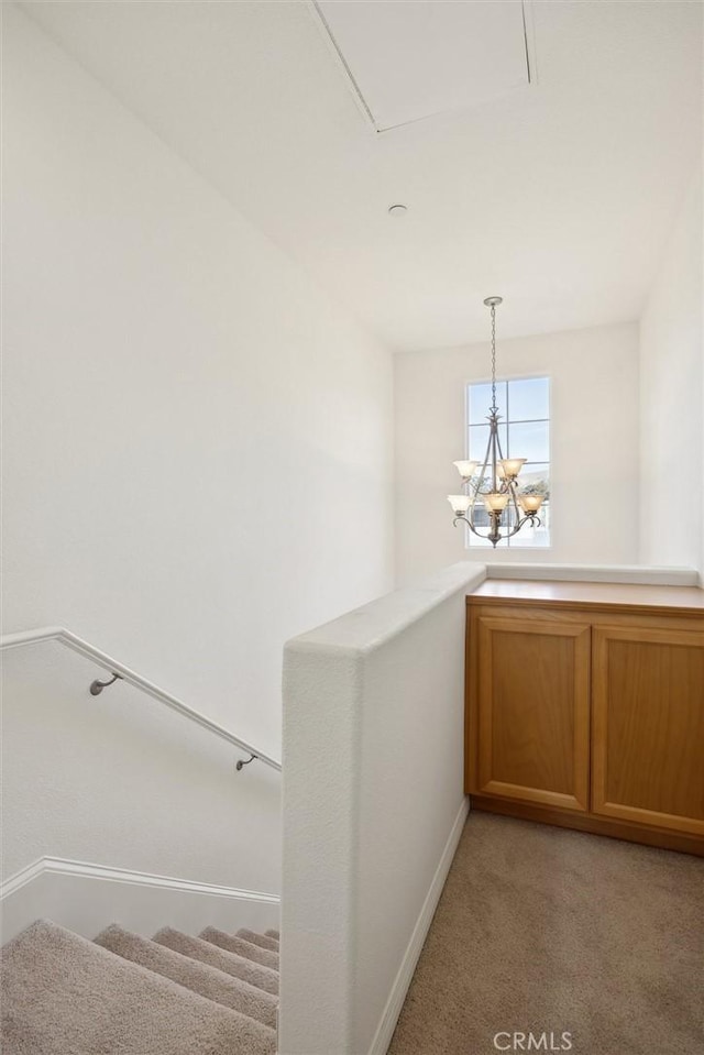 interior space with light colored carpet and a notable chandelier