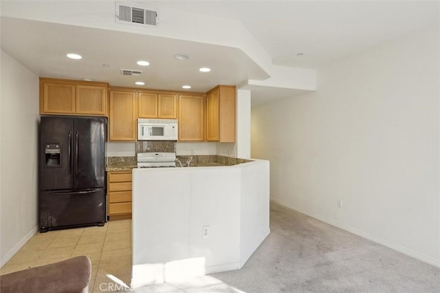 kitchen featuring kitchen peninsula, light colored carpet, and white appliances