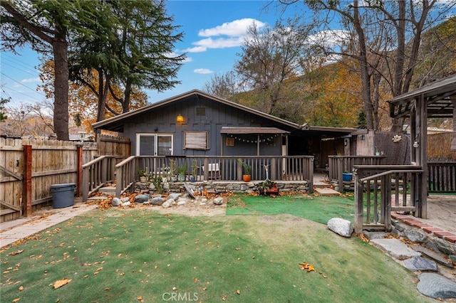 rear view of property with a yard