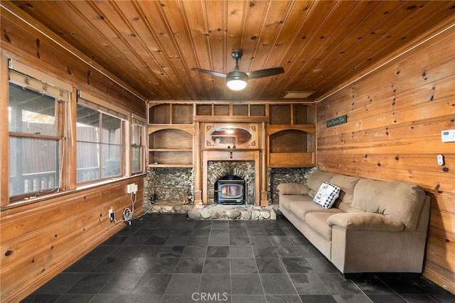 unfurnished living room featuring a wood stove, wood walls, and wood ceiling