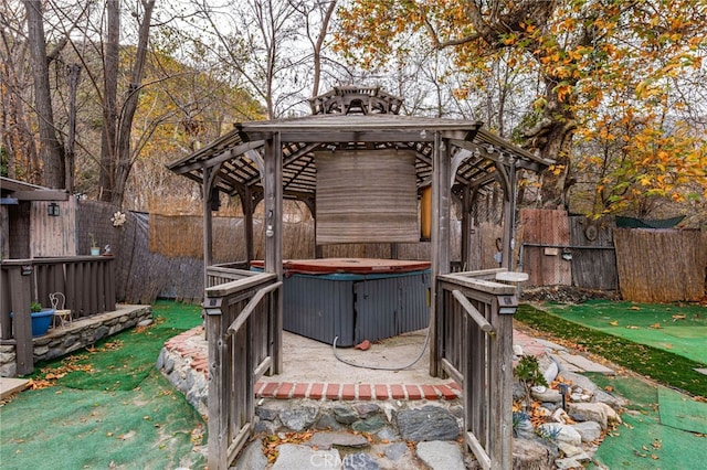 wooden deck featuring a gazebo and a hot tub