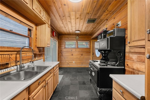 kitchen with light brown cabinets, wood ceiling, wooden walls, and sink