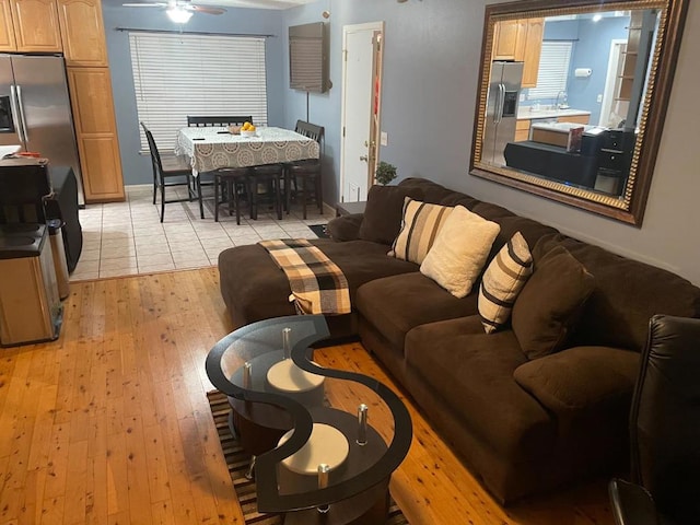 living room featuring ceiling fan and light hardwood / wood-style flooring