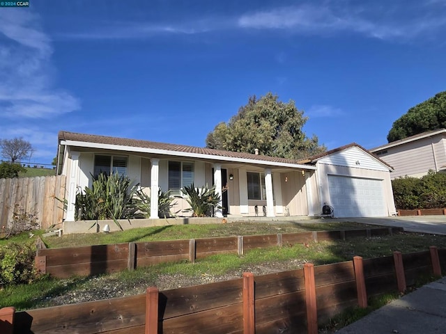 single story home with covered porch and a garage