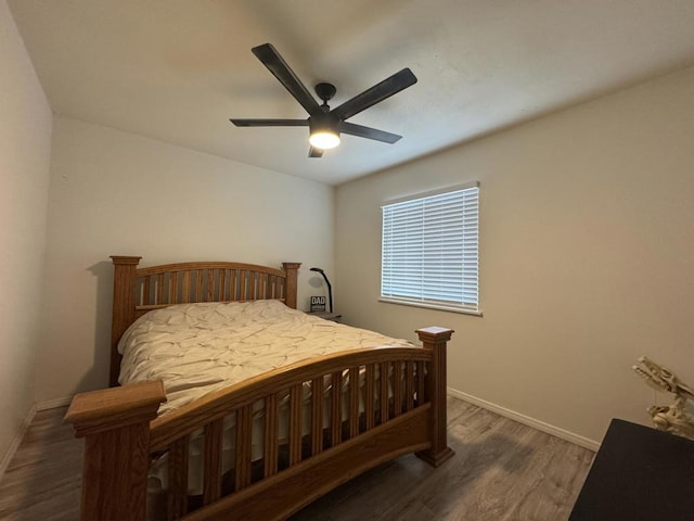 bedroom with ceiling fan and dark hardwood / wood-style floors