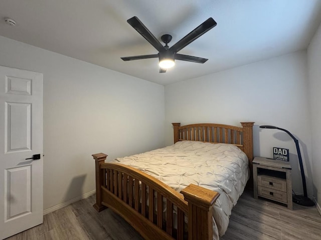 bedroom with ceiling fan and dark hardwood / wood-style flooring