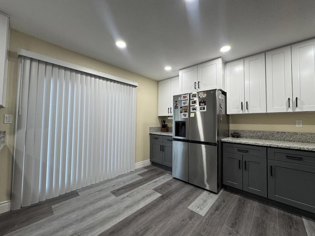 kitchen featuring stainless steel refrigerator with ice dispenser, light hardwood / wood-style floors, white cabinets, and gray cabinets