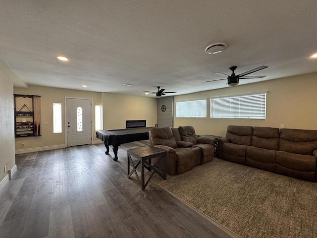 living room featuring dark wood-type flooring, ceiling fan, a healthy amount of sunlight, and billiards