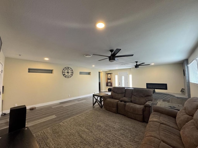 living room with ceiling fan and dark hardwood / wood-style floors