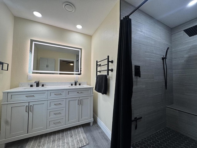 bathroom featuring ceiling fan, hardwood / wood-style floors, vanity, and a shower with curtain