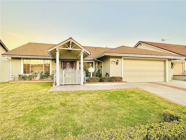 view of front facade with a yard and a garage